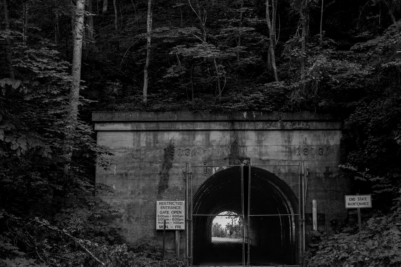 A short, arched tunnel at the Radford Army Ammunition Plant, with a closed chain-link gate